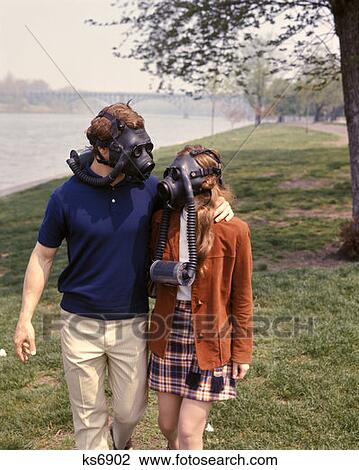 1970 1970S Young Couple Man Woman Wear Gas Mask Masks Walking By River Clean Air Smog Environment Ecology Rrr Retro View Large Photo Image Stock Image - 1970 1970S Young Couple Man Woman Wear Gas Mask Masks Walking By River Clean Air Smog Environment Ecology Rrr Retro . Fotosearch