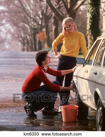 1970 1970S Young Couple Teens Boy Girl Man Woman Washing Car Wash Auto 1980 1980S View Large Photo Image Stock Image - 1970 1970S Young Couple Teens Boy Girl Man Woman Washing Car Wash Auto 1980 1980S . Fotosearch