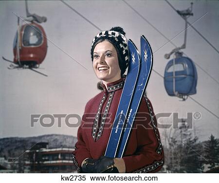 1970 197S Retro Woman In Winter Gear Hat Holding Skis Ski Lift In Background View Large Photo Image Stock Photography - 1970 197S Retro Woman In Winter Gear Hat Holding Skis Ski Lift In Background. Fotosearch