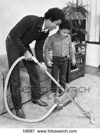 1970S 1980S African-American Man Father And Son Boy Vacuuming Carpet Vacuum View Large Photo Image Stock Photo - 1970S 1980S African-American Man Father And Son Boy Vacuuming Carpet Vacuum . Fotosearch
