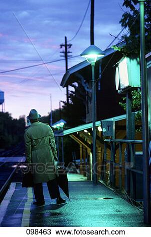 Stock Image - 1970S 1980S Man Commuter Waiting For Train . Fotosearch