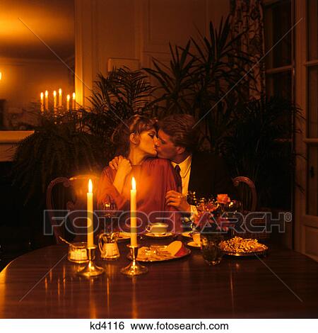1970S 1980S Man Woman Couple Kissing At Dining Table Candlelight Romance Romantic Date Dessert Coffee Flowers Relationship View Large Photo Image Stock Photograph - 1970S 1980S Man Woman Couple Kissing At Dining Table Candlelight Romance Romantic Date Dessert Coffee Flowers Relationship. Fotosearch