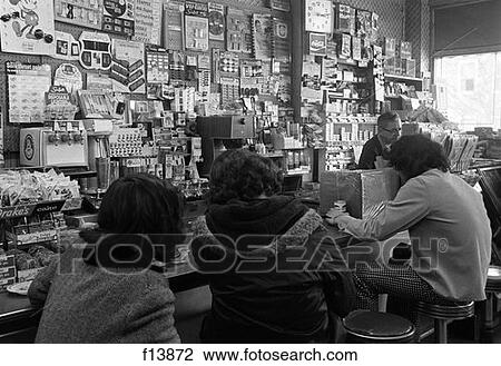 1970S 3 Teen Boys With Backs To Camera Sitting On Stools At The Counter Of A Soda Fountain Shop View Large Photo Image Stock Image - 1970S 3 Teen Boys With Backs To Camera Sitting On Stools At The Counter Of A Soda Fountain Shop . Fotosearch