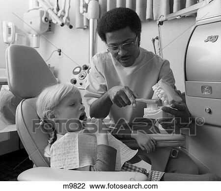 1970S African-American Dentist Showing Little Girl How To Brush Her Teeth On Large Model View Large Photo Image Stock Image - 1970S African-American Dentist Showing Little Girl How To Brush Her Teeth On Large Model . Fotosearch