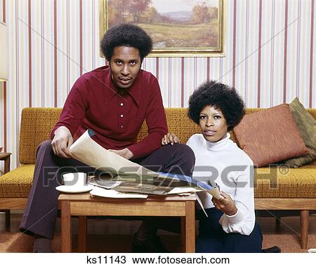 1970S African-American Man Woman Couple Husband Wife Looking New House Blueprint Coffee Table Portrait Afro Retro View Large Photo Image Stock Image - 1970S African-American Man Woman Couple Husband Wife Looking New House Blueprint Coffee Table Portrait Afro Retro . Fotosearch