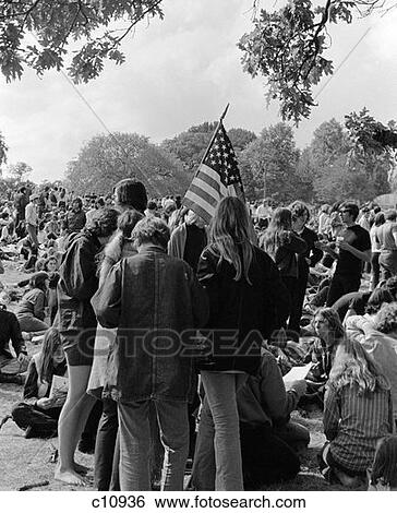 1970S Back View Of Crowd Of Young Men & Women Teenage Students Participating In Protest Demonstration Holding American Flag View Large Photo Image Stock Photograph - 1970S Back View Of Crowd Of Young Men & Women Teenage Students Participating In Protest Demonstration Holding American Flag. Fotosearch