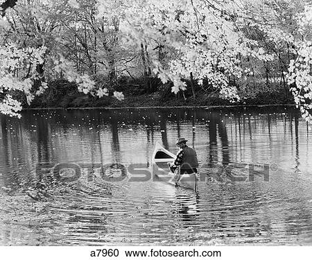 1970S Back View Of Older Man Fishing Off Of Canoe In Lake View Large Photo Image Stock Image - 1970S Back View Of Older Man Fishing Off Of Canoe In Lake . Fotosearch