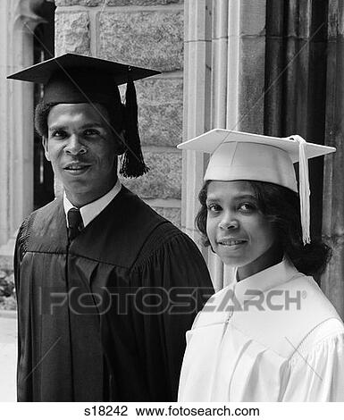 1970S Black Couple Portrait Wearing Graduation Gowns View Large Photo Image Stock Image - 1970S Black Couple Portrait Wearing Graduation Gowns . Fotosearch