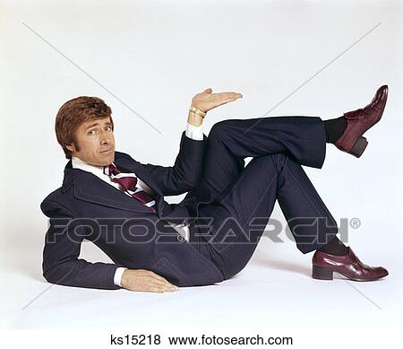 1970S Business Man Lying On His Side Making Gesture With Hand Wearing Leisure Suit View Large Photo Image Stock Photo - 1970S Business Man Lying On His Side Making Gesture With Hand Wearing Leisure Suit. Fotosearch