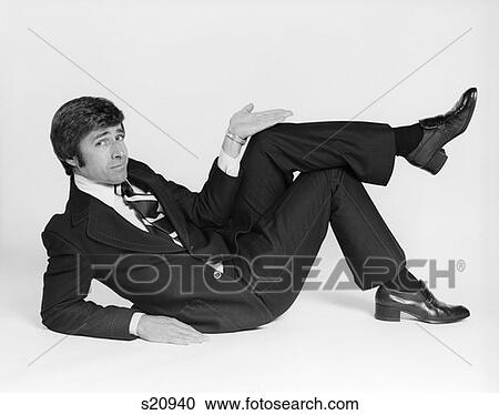 1970S Business Man Lying On Side Making Gesture With Hand View Large Photo Image Stock Image - 1970S Business Man Lying On Side Making Gesture With Hand . Fotosearch