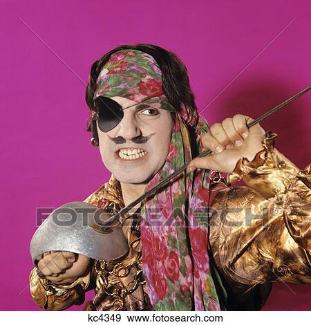 1970S Character Man In Pirate Costume Holding A Sword Funny Face Exspression Moustache Gritting Teeth Swashbuckler View Large Photo Image Stock Photo - 1970S Character Man In Pirate Costume Holding A Sword Funny Face Exspression Moustache Gritting Teeth Swashbuckler. Fotosearch