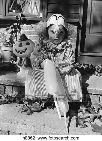 1970S Child In Trick Or Treat Clown Costume Sitting On Front Door Step Holding Balloons View Large Photo Image Stock Image - 1970S Child In Trick Or Treat Clown Costume Sitting On Front Door Step Holding Balloons. Fotosearch