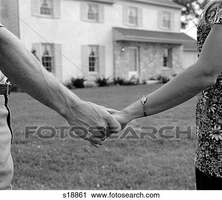 1970S Close-Up Of Couple Holding Hands With New Home In Background View Large Photo Image Stock Image - 1970S Close-Up Of Couple Holding Hands With New Home In Background . Fotosearch