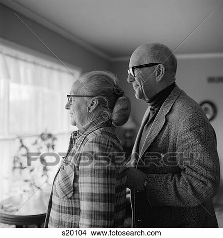 1970S Couple Man Woman Mature Seniors Profile Portrait Looking Out Of Window View Large Photo Image Picture - 1970S Couple Man Woman Mature Seniors Profile Portrait Looking Out Of Window. Fotosearch