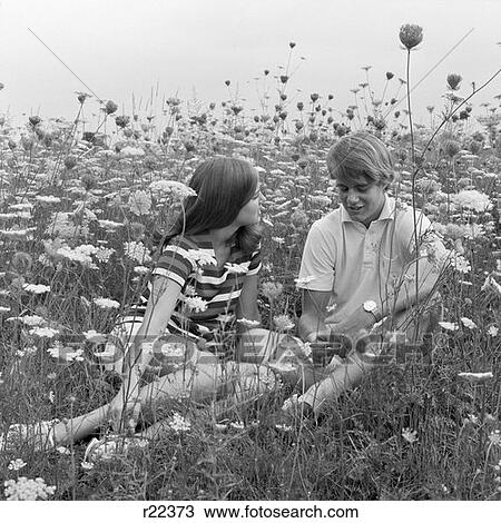 1970S Couple Sitting & Talking In Field With Queen Anne'S Lace View Large Photo Image Stock Image - 1970S Couple Sitting & Talking In Field With Queen Anne'S Lace . Fotosearch