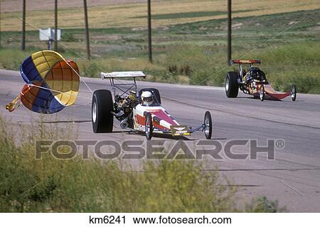 1970S Drag Race Two Alcohol Burning Cars Dragsters On Strip Near Finish Open Drogue Parachute Racing Speed Slow Down View Large Photo Image Stock Image - 1970S Drag Race Two Alcohol Burning Cars Dragsters On Strip Near Finish Open Drogue Parachute Racing Speed Slow Down. Fotosearch