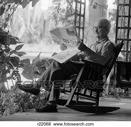 1970S Elderly Man In Rocker Reading Newspaper On Porch View Large Photo Image Stock Photo - 1970S Elderly Man In Rocker Reading Newspaper On Porch . Fotosearch