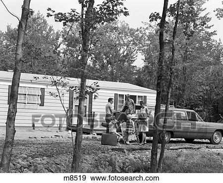1970S Family Of 5 Unloading Suitcases & Lounge Chairs From Trunk Of Station Wagon In Front Of Mobile Home In Woods View Large Photo Image Stock Photo - 1970S Family Of 5 Unloading Suitcases & Lounge Chairs From Trunk Of Station Wagon In Front Of Mobile Home In Woods . Fotosearch