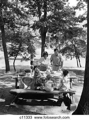 1970S Family Of Five At Table In Park Under Trees Having Picnic View Large Photo Image Stock Image - 1970S Family Of Five At Table In Park Under Trees Having Picnic . Fotosearch