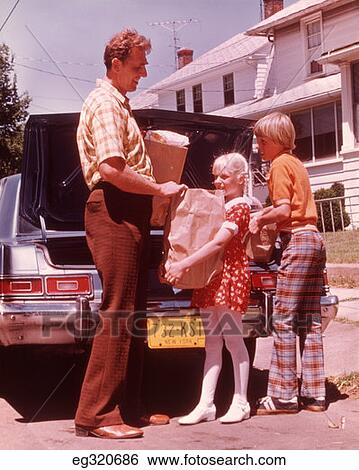 1970S Father And Children Unloading Groceries From Car View Large Photo Image Stock Photograph - 1970S Father And Children Unloading Groceries From Car. Fotosearch
