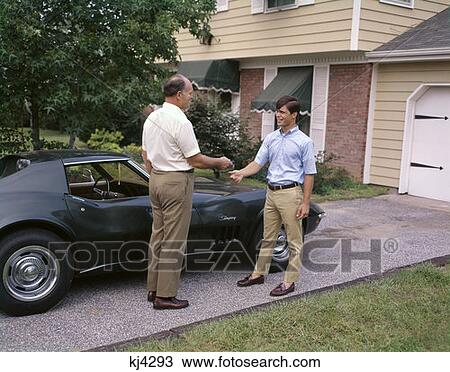 1970S Father Handing Teenage Son Keys To Family Car Man Boy Symbolic Story View Large Photo Image Stock Image - 1970S Father Handing Teenage Son Keys To Family Car Man Boy Symbolic Story. Fotosearch