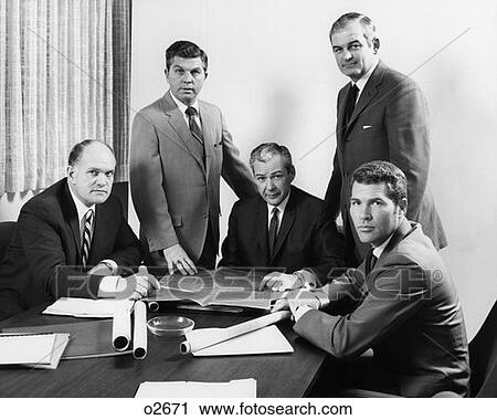 Stock Image - 1970S Five Men Executives Around Conference Look At Camera. Fotosearch