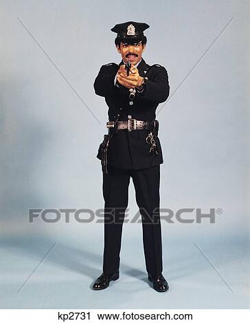 1970S Full Figure Standing Policeman Officer Man Pointing Gun At Camera African-American Police Studio View Large Photo Image Stock Image - 1970S Full Figure Standing Policeman Officer Man Pointing Gun At Camera African-American Police Studio . Fotosearch
