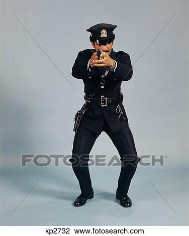 1970S Full Length Police Officer Man Pointing Gun At Camera Action Stance Standing Uniform African-American View Large Photo Image Stock Image - 1970S Full Length Police Officer Man Pointing Gun At Camera Action Stance Standing Uniform African-American . Fotosearch