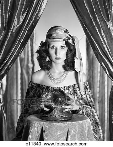 1970S Gypsy Between Sparkly Curtains With Hands Around Crystal Ball Staring Into Camera  View Large Photo Image Stock Image - 1970S Gypsy Between Sparkly Curtains With Hands Around Crystal Ball Staring Into Camera . Fotosearch