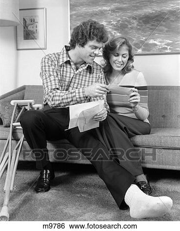 1970S Man And Woman Broken Foot On Stool Crutches Smiling At Insurance Check View Large Photo Image Stock Photograph - 1970S Man And Woman Broken Foot On Stool Crutches Smiling At Insurance Check . Fotosearch