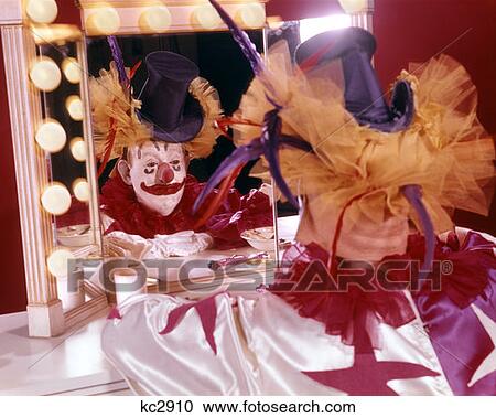 1970S Man Dressed As Clown Sitting At Makeup Mirror Reflection Costume Hat View Large Photo Image Stock Image - 1970S Man Dressed As Clown Sitting At Makeup Mirror Reflection Costume Hat. Fotosearch