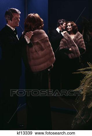 1970S Man Helping Woman With Fur Stole Romantic Reflected In Mirror View Large Photo Image Stock Photo - 1970S Man Helping Woman With Fur Stole Romantic Reflected In Mirror . Fotosearch
