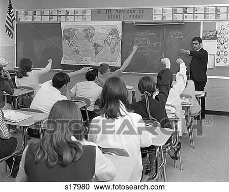 1970S Man Teacher Pointing To Raised Hand Teen Classroom Students Seen From Behind Look To Chalkboard World Map History Class View Large Photo Image Stock Image - 1970S Man Teacher Pointing To Raised Hand Teen Classroom Students Seen From Behind Look To Chalkboard World Map History Class. Fotosearch