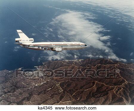 Stock Photography - 1970S Mcdonnell Douglas Dc 10 Aloft Over Catalina Island California Aerial Clouds Jet Passenger Commercial Airline Travel. Fotosearch