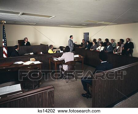 Stock Image - 1970'S Men Women Courtroom Scene Attorney Lawyer Talking To Jury Judge Presiding Trial . Fotosearch