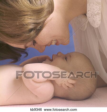 1970S Mother And Baby Facing Each Other Smiling Laughing View Large Photo Image Stock Photograph - 1970S Mother And Baby Facing Each Other Smiling Laughing. Fotosearch