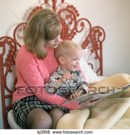 1970S Mother And Son Sitting On Bed Reading A Story View Large Photo Image Stock Photo - 1970S Mother And Son Sitting On Bed Reading A Story. Fotosearch