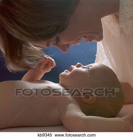 Stock Photography - 1970S Mother Looking Down On Baby. Fotosearch