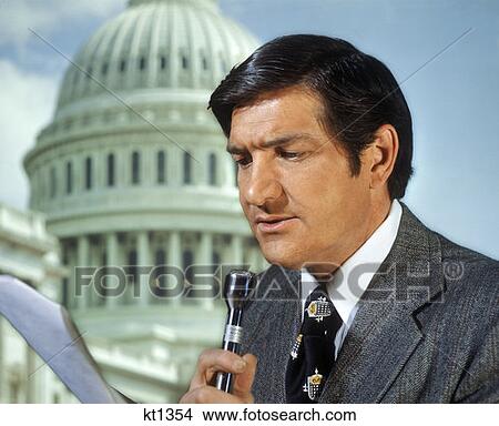1970S Newsman Reporter Reading Script Into Microphone In Front Of Washington Dc Capitol Dome View Large Photo Image Picture - 1970S Newsman Reporter Reading Script Into Microphone In Front Of Washington Dc Capitol Dome . Fotosearch