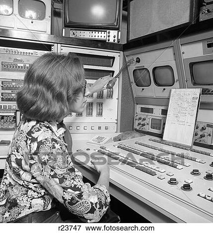 Stock Photo - 1970S Of Woman Behind Tv Studio Control Panel Making Adjustments To Microphone . Fotosearch