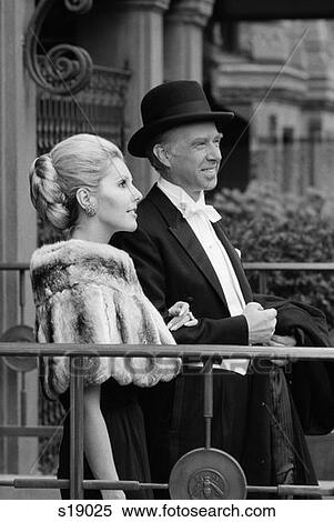 1970S Older Couple Dressed To Go Out Man In Tuxedo Woman In Dress And Fur Cape Standing Arm In Arm Outdoor View Large Photo Image Stock Photography - 1970S Older Couple Dressed To Go Out Man In Tuxedo Woman In Dress And Fur Cape Standing Arm In Arm Outdoor . Fotosearch