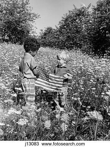 1970S Pair Of Boys One White One Black Hispanic Standing In Field Of Queen Anne'S Lace Holding Up American Flag View Large Photo Image Stock Image - 1970S Pair Of Boys One White One Black Hispanic Standing In Field Of Queen Anne'S Lace Holding Up American Flag. Fotosearch