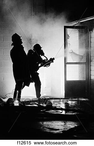 1970S Pair Of Firefighters Pointing Hose Through Open Door Of Burning Building View Large Photo Image Stock Photography - 1970S Pair Of Firefighters Pointing Hose Through Open Door Of Burning Building . Fotosearch