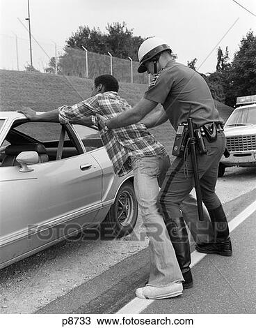1970S Policeman Searching African-American Man Spread Eagle Against Car View Large Photo Image Stock Image - 1970S Policeman Searching African-American Man Spread Eagle Against Car. Fotosearch