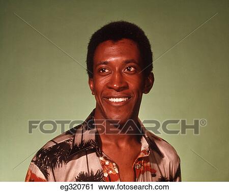 Stock Image - 1970S Portrait African-American Man Green Background. Fotosearch