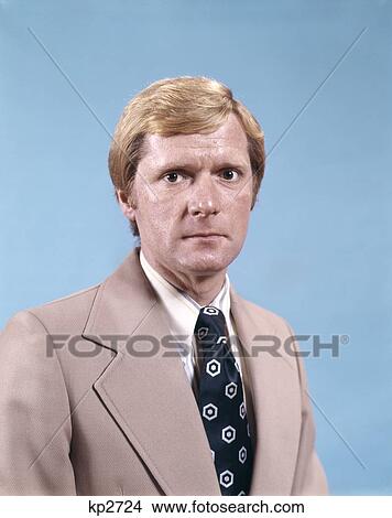 1970S Portrait Man Business Suit Tie Serious Expression Waist Up Retro Fashion View Large Photo Image Picture - 1970S Portrait Man Business Suit Tie Serious Expression Waist Up Retro Fashion . Fotosearch