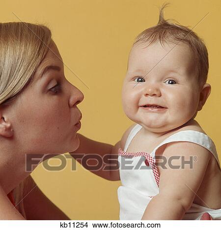 Picture - 1970S Portrait Mother And Baby Mother Making Face At Baby Looking At Camera Smiling. Fotosearch