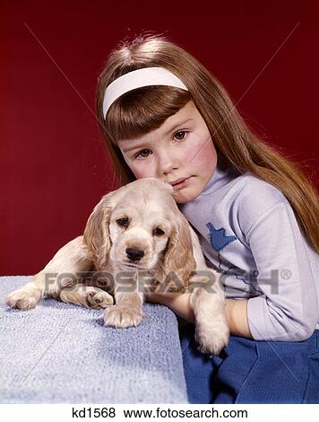 1970S Portrait Serious Little Girl Hugging Her Cocker Spaniel Puppy Dog View Large Photo Image Stock Photo - 1970S Portrait Serious Little Girl Hugging Her Cocker Spaniel Puppy Dog . Fotosearch