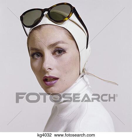 1970S Portrait Woman White Turtle Neck White Aviator Helmet Hat Strap Fashion Beauty Style Sunglasses Push Up On Head View Large Photo Image Stock Image - 1970S Portrait Woman White Turtle Neck White Aviator Helmet Hat Strap Fashion Beauty Style Sunglasses Push Up On Head. Fotosearch
