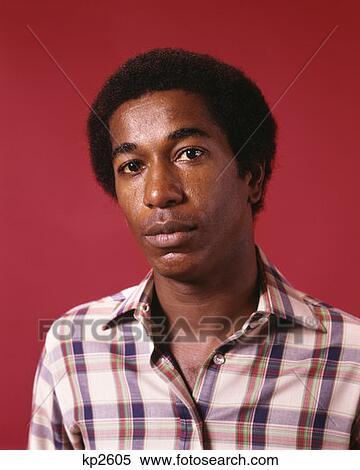 1970S Portrait Young African-American Man Serious Expression Plaid Shirt Retro View Large Photo Image Stock Photography - 1970S Portrait Young African-American Man Serious Expression Plaid Shirt Retro . Fotosearch